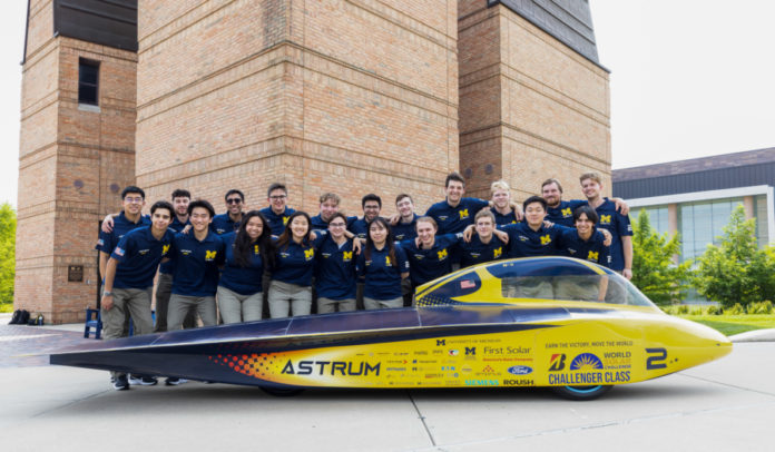 U-M Solar Car Team poses with their vehicle 