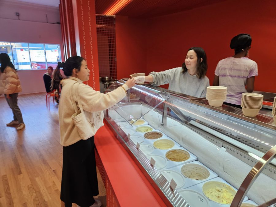 Matteson handling a free sample to a customer on opening day. Photo by Drew Saunders. 