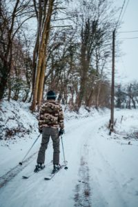 A person skiing on a trial.