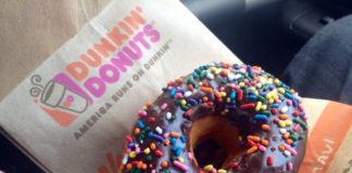 A donut with sprinkles from Dunkin' Donuts.