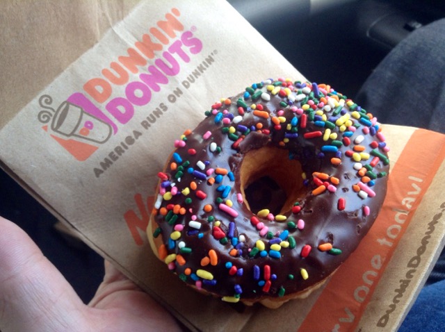 A donut with sprinkles from Dunkin' Donuts.