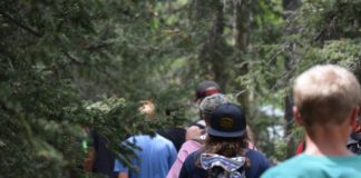 A group of people hiking through the woods.