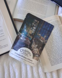 A bag of tea sitting next to books.