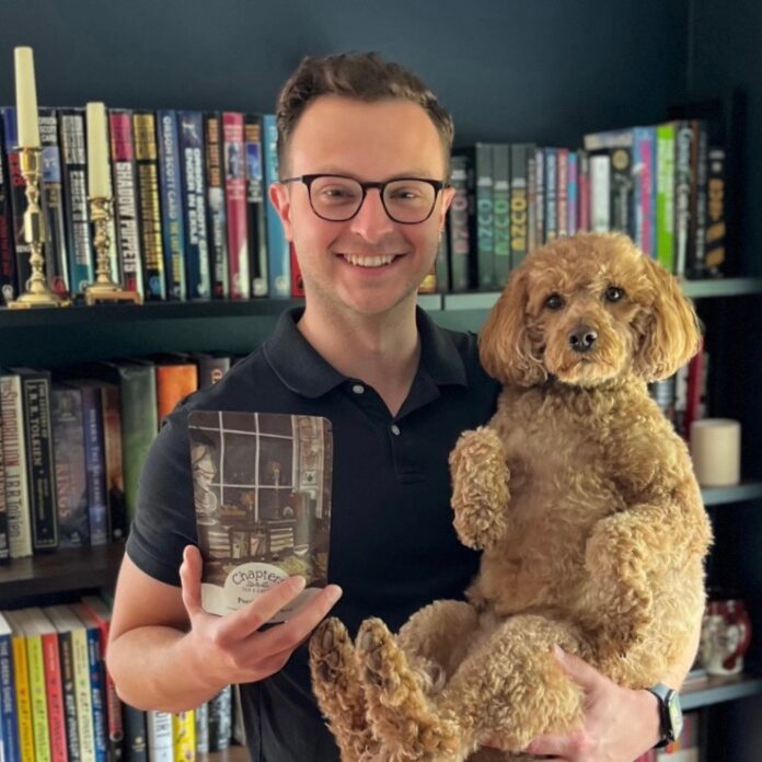 A person holding a bag of tea and a dog.