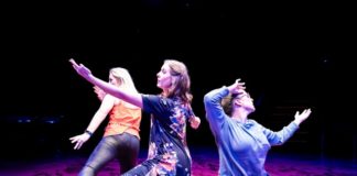 A group of actors performing on stage.