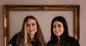 Two people smiling at the camera.