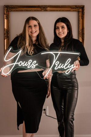 Two people smiling at the camera.