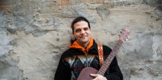 A preformer with a guitar.