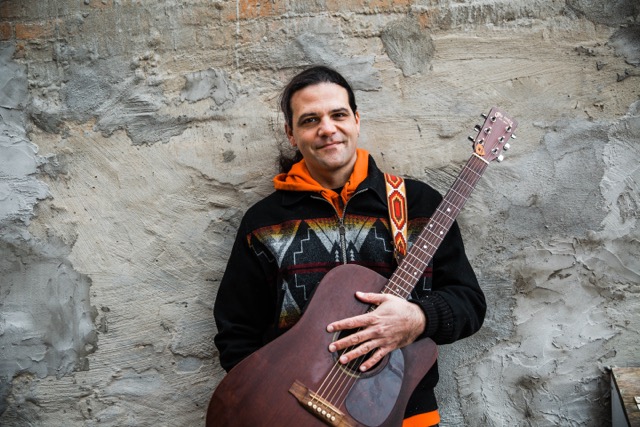 A preformer with a guitar.