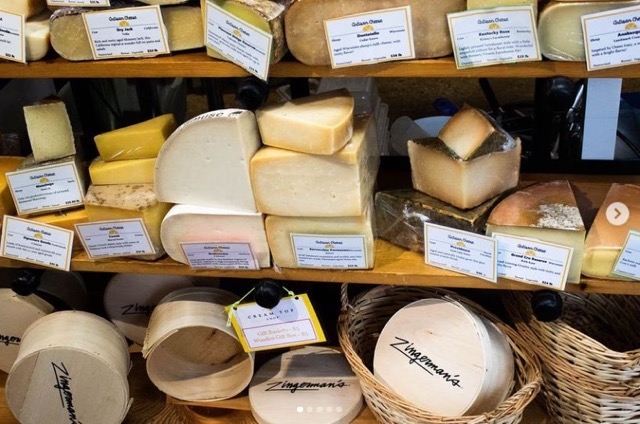 An assortment of cheese on a shelf.