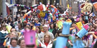 A photo of a festival on the streets.