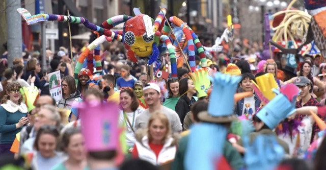 A photo of a festival on the streets.