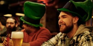 A person drinking beer at a bar.