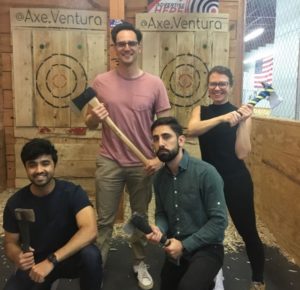 A group of people at a throwing axe place.