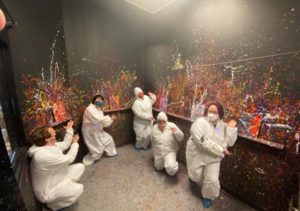 A group of people painting on walls.