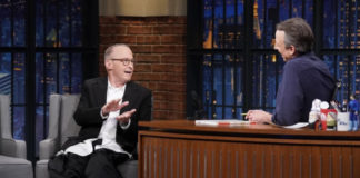 Two people talking on a stage.