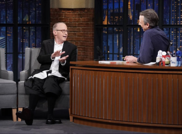 Two people talking on a stage.