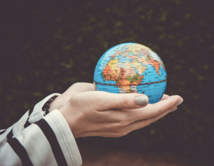 Earth Day A person holding a glob in their hands.