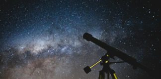 Photo of the night sky and a telescope