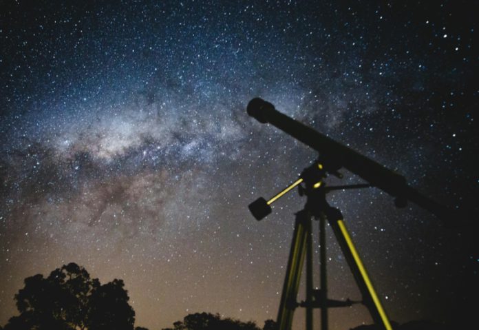 Photo of the night sky and a telescope