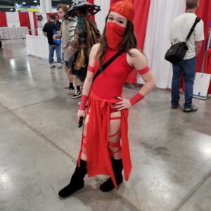 A person dressed up for comic con.