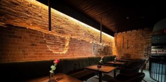 Restaurant table with rose on it.