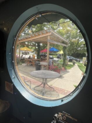 An outdoor seating area thrrough a window.