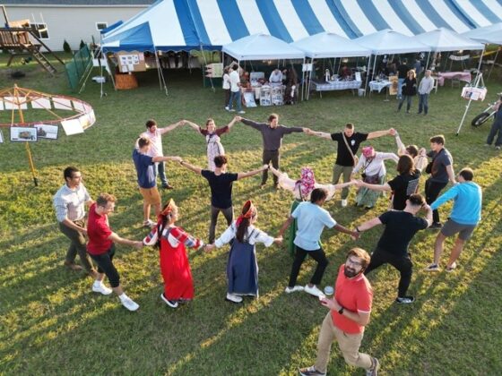 A group of people dancing in the park.