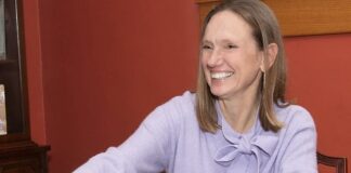 Woman sitting at table smiling