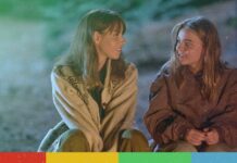 Two people sitting down outside.