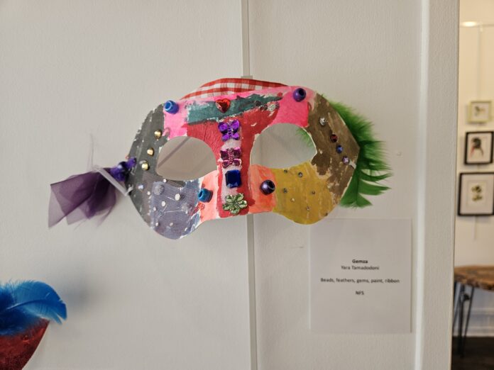 Colorful mask against white wall