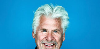 Man in black against blue background