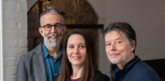 Two men and one woman standing