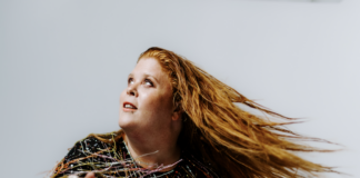 Woman flipping hair in dress