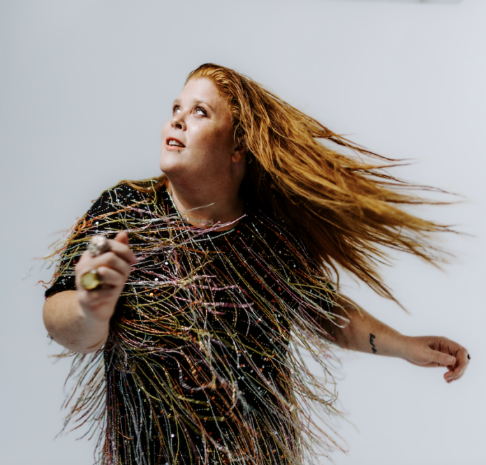 Woman flipping hair in dress