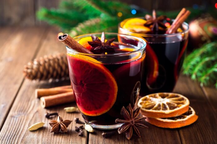 Mulled wine on table by spices
