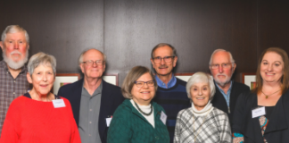 Group of people smiling and standing