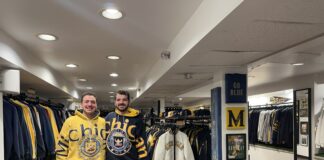 Photos of two men in vintage store in Michigan shirts