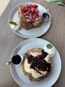 Two plates of sweet brunch items