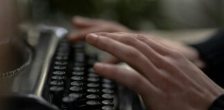 hands typing on typewriter