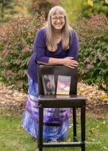 Photo of woman posing with books.