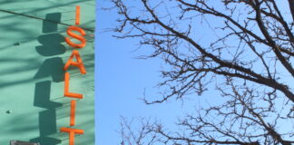 Blue vertical sign with orange letters