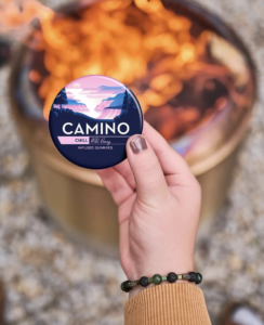 Photo of hand holding edibles by fire