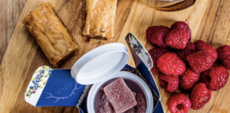 gummies with fruit around it on wood table