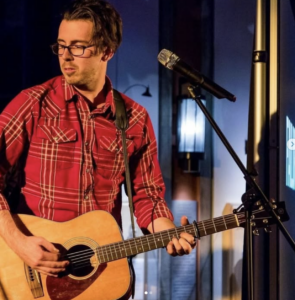Man singing and playing guitar