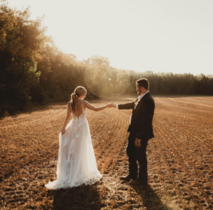 Bride and groom in field