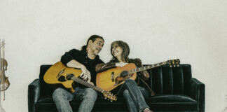Couple with guitars on couch
