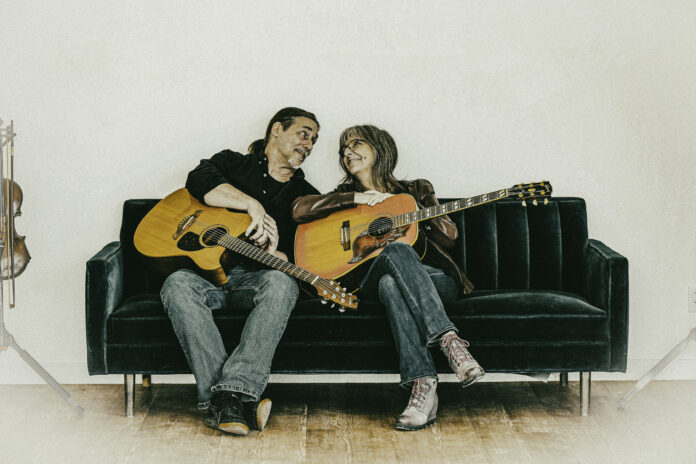 Couple with guitars on couch