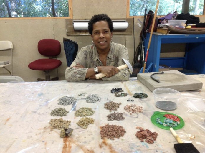 The artist Wasentha Young with her artistic materials.