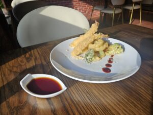 The tempura appetizer comes with a nice, simply dipping sauce. And they add an ellipsis of sauce trailing away from the seafood and vegetables that make up the dish, like the chef is purposefully leaving something unsaid. Photo by Drew Saunders.